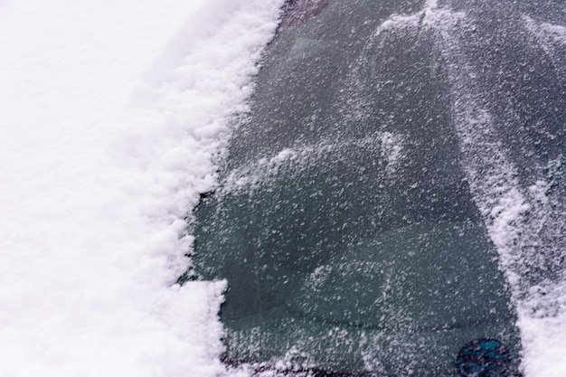 Snow-covered car window. Car Covered In Fresh White Snow, Cars covered in snow after a blizzard.