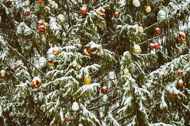 Snow-covered Christmas tree with decorations