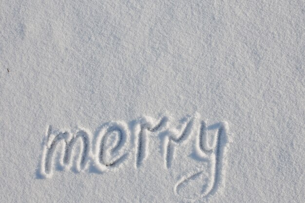 Snow-covered lake. Snow cover. Copy Space. text merry written with finger