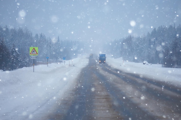 snow and fog on the winter road landscape / view of the seasonal weather a dangerous road, a winter lonely landscape