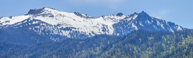 Snow melts on the mountain peaks, sunny spring day	