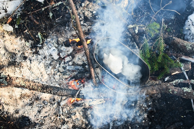 Snow in a pan on the fire