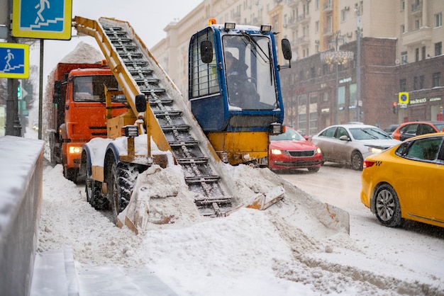 Snow plow removing snow from the road b