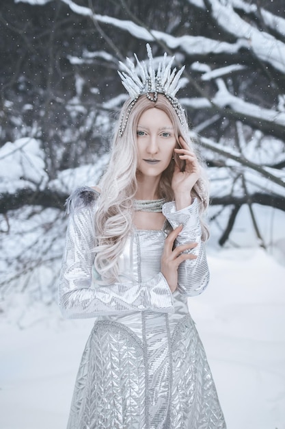 Snow Queen cosplay in the winter forest background Art photo