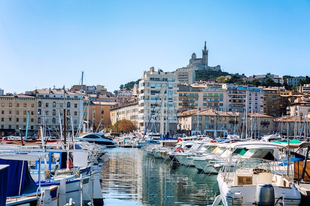 Snow-white sailing yachts in a marina in Marseille on a bright sunny day. Beautiful view.