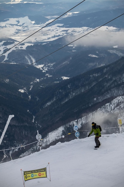 Snowboarder at the slope of chopok mountain in slovakia