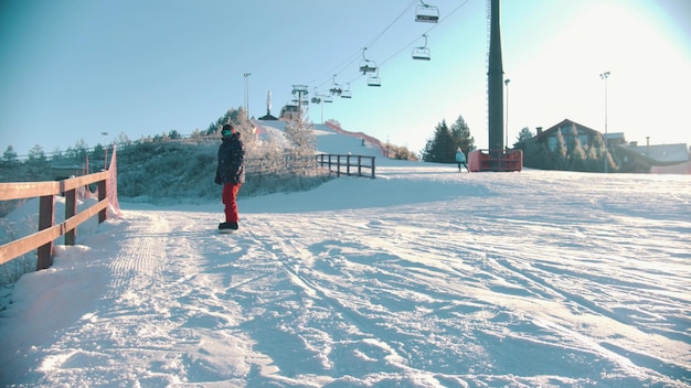 Snowboarding concept  an injured man with prosthetic leg skating down the mountain