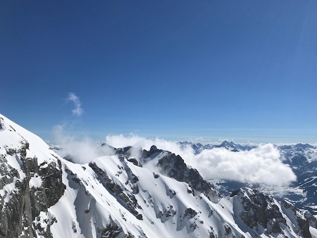 Snowcapped mountains against blue sky during winter