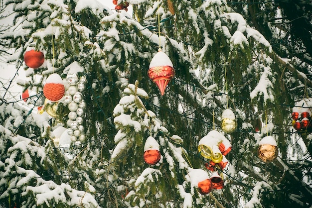 Snowcovered Christmas tree with decorations New Year's concept