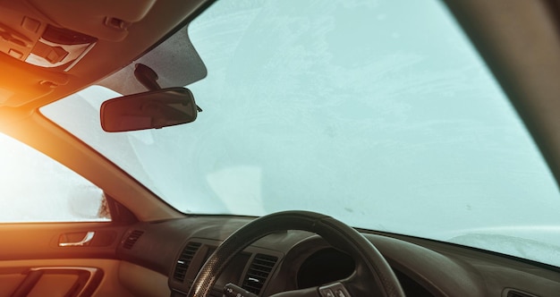 Snowcovered rightdrive cars interior frosted car glass snowcovered car windshield View from inside the car during a winter day Inside of right wheel vehicle