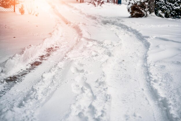 Photo a snowcovered road that has been plowed snow removal after blizzard