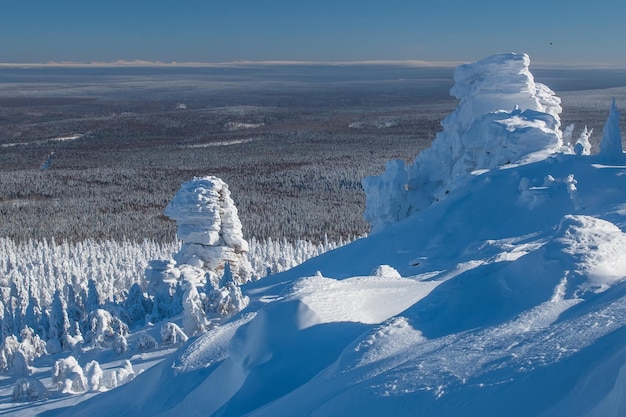 Snowcovered slope in the mountains in the cold polar winter on a sunny day