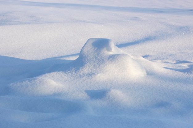 Snowdrift and shadow Snowy background winter snow texture on a sunny evening