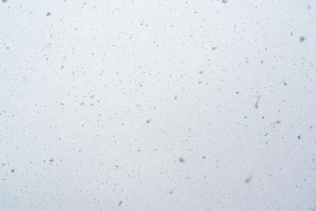 Snowfall texture snowflakes on blurred background weather design High quality photo