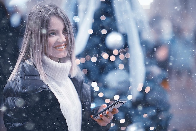 snowfall woman city christmas outside, city portrait in snowfall, young model posing in festive look