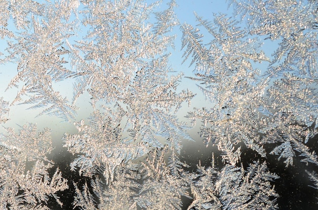 Snowflakes frost rime macro on window glass pane