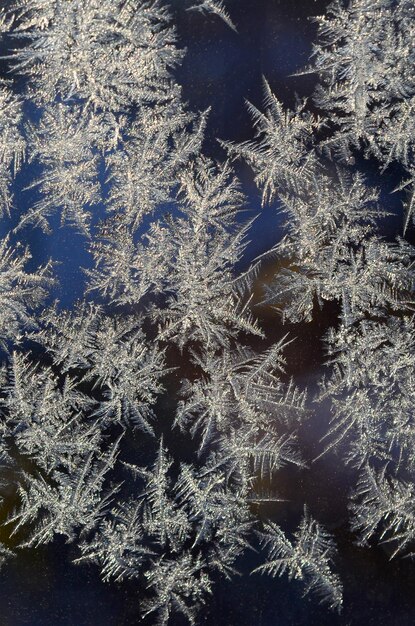 Snowflakes frost rime macro on window glass pane