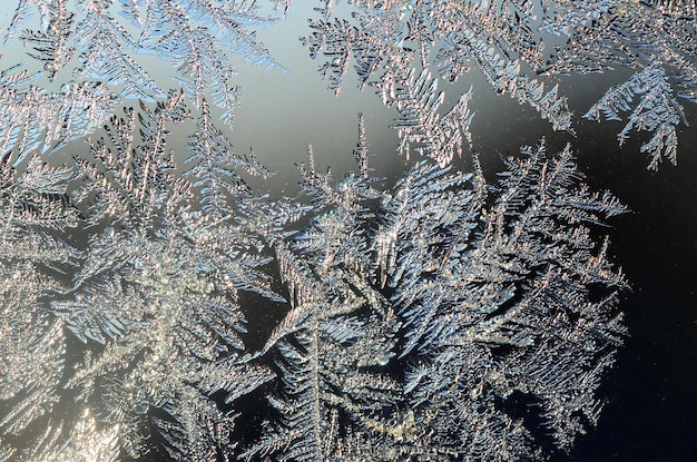 Snowflakes frost rime macro on window glass pane