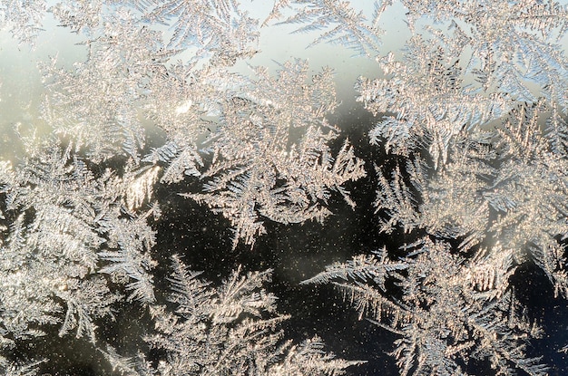 Snowflakes frost rime macro on window glass pane