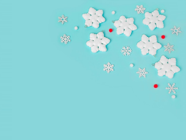 snowflakes on light blue background pastel colors Christmas holiday composition copy space