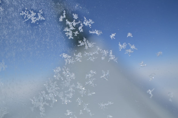 Snowflakes on the window of the plane.