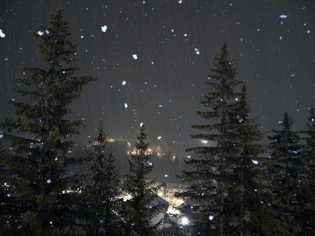 Snowing at night in dolomites mountains