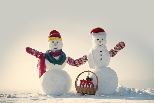 Snowman from snow in hat christmas for snow man in winter outdoor with gift box