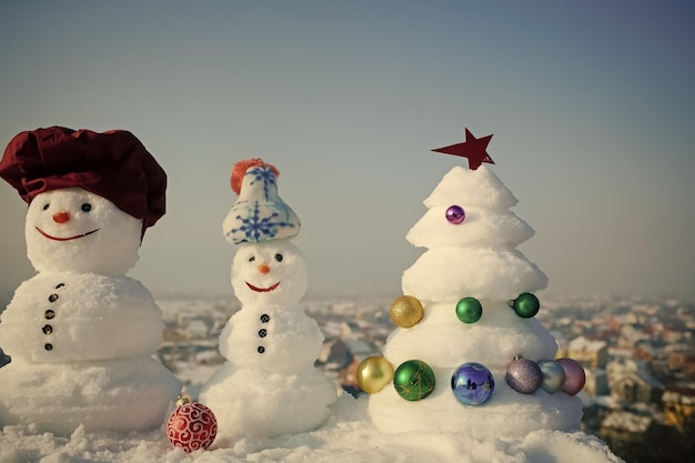 Snowmen on blue sky background