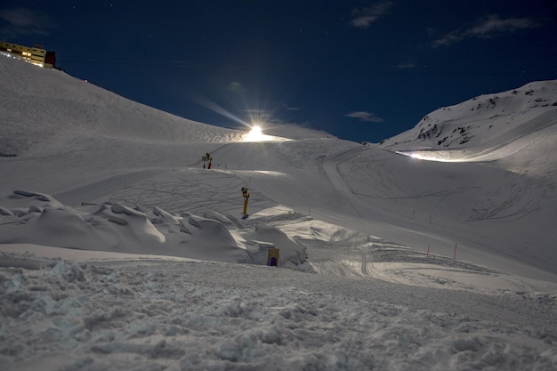 Snowmobile on ski run at night