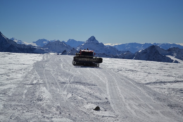 Snowplow in the mountains cleans the road from snow