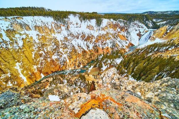 Snowy canyons of Yellowstone from overlook with Upper Falls