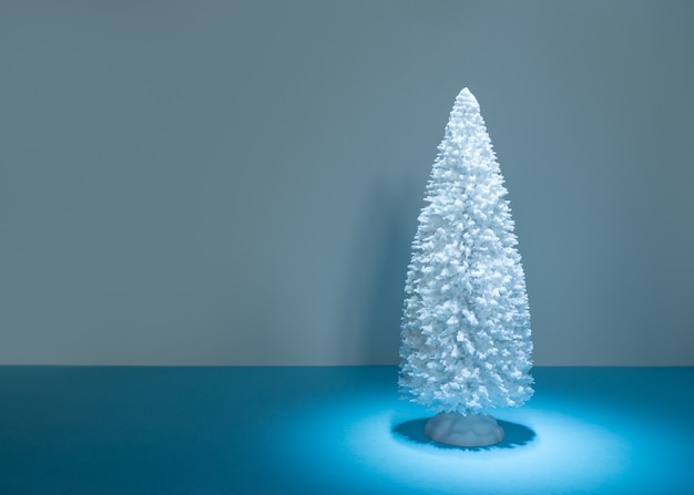 Snowy Christmas tree on blue table