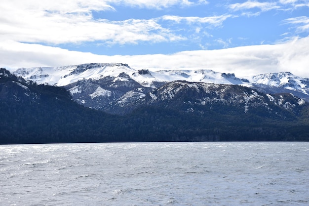 a snowy mountain with a mountain in the background