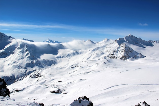 Snowy Mountains in the clouds blue sky Caucasus Elbrus