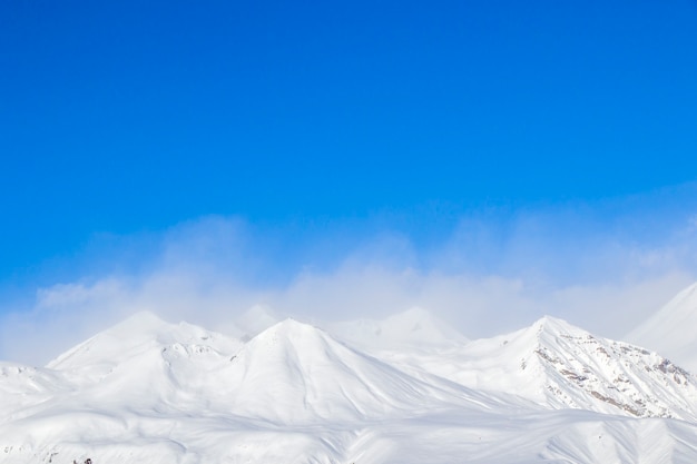 Snowy mountains landscape in Gudauri, Georgia. Sunny day.