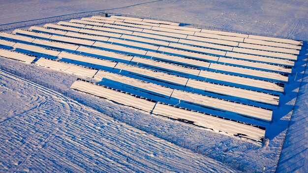 Snowy solar panels in winter aerial view of Poland Europe