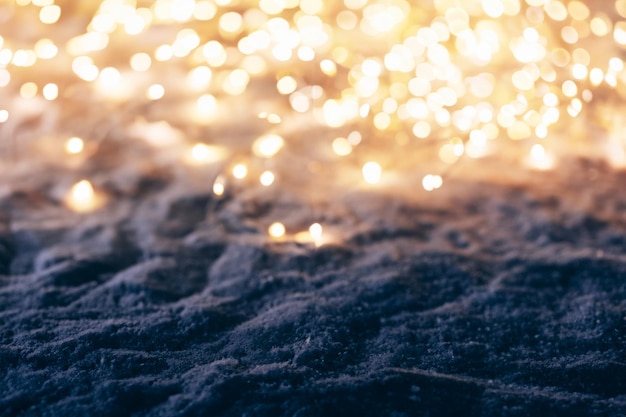 Photo snowy winter background with fairy lights