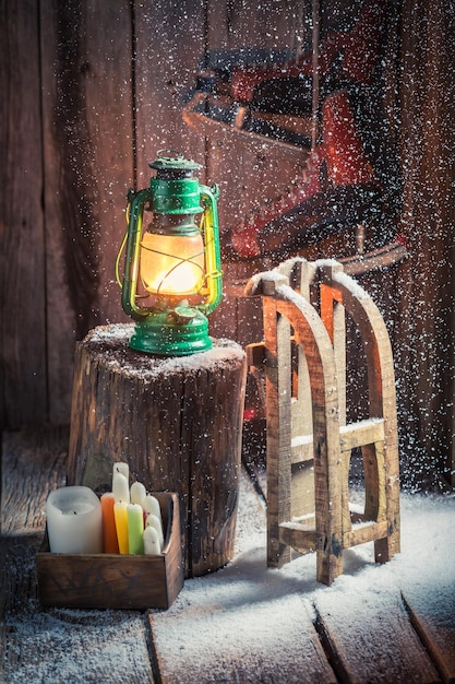 Snowy wooden cottage with sleigh and wax