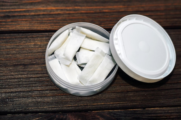 Snus box with nicotine pouches on wooden background