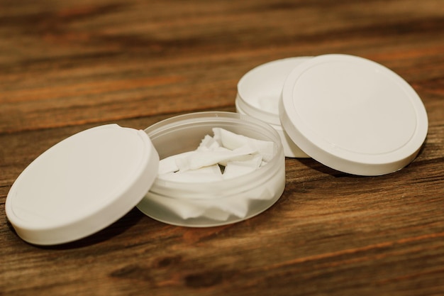 Snus box with nicotine pouches on wooden background