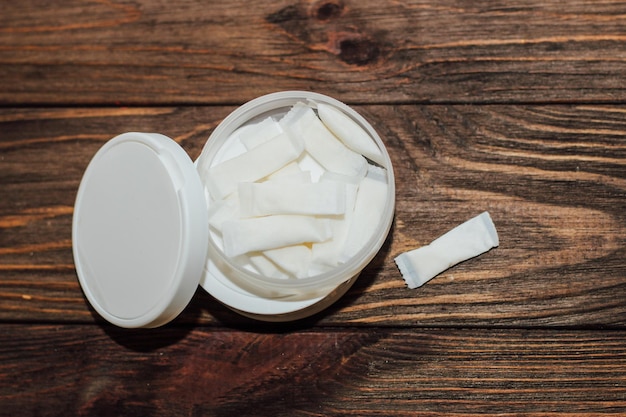 Snus box with nicotine pouches on wooden background