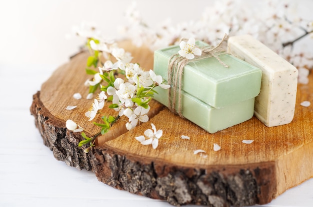 Soap banner. Aromatic Natural Soap with sakura flowers on wooden background, close up