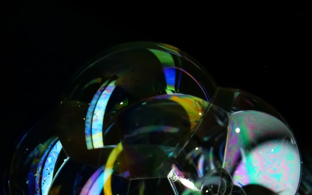 Soap bubble close up isolated on black background