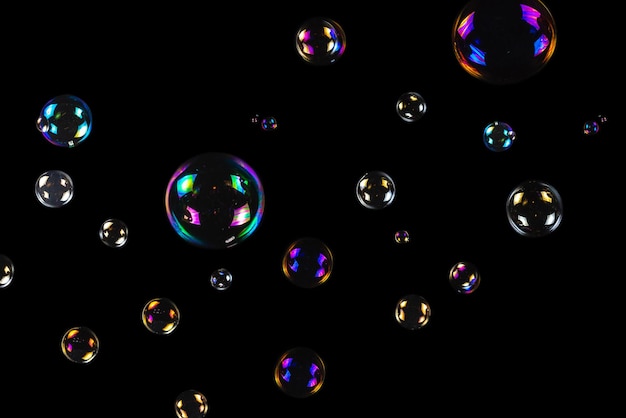 Soap bubbles isolated on a black background Copy space