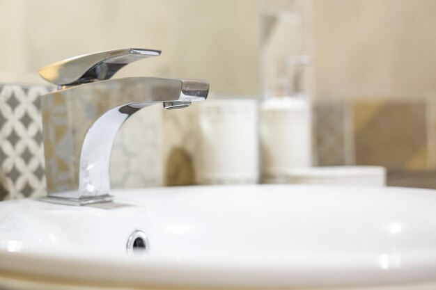 Soap and shampoo dispensers on Water tap sink with faucet in expensive loft bathroom