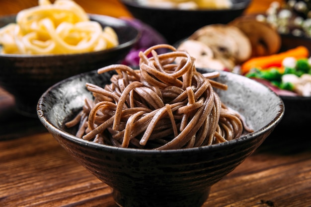 Soba japanese buckwheat noodles in a black bowl