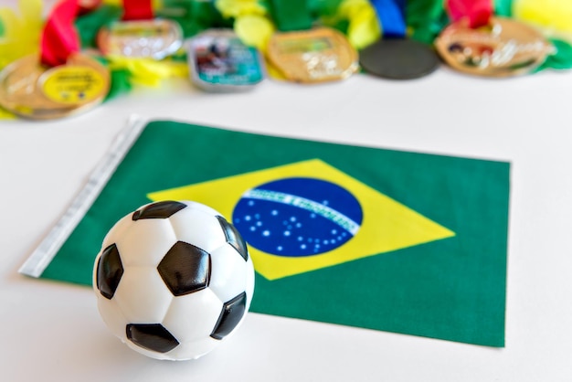 Soccer ball brazilian flag and medals on white background