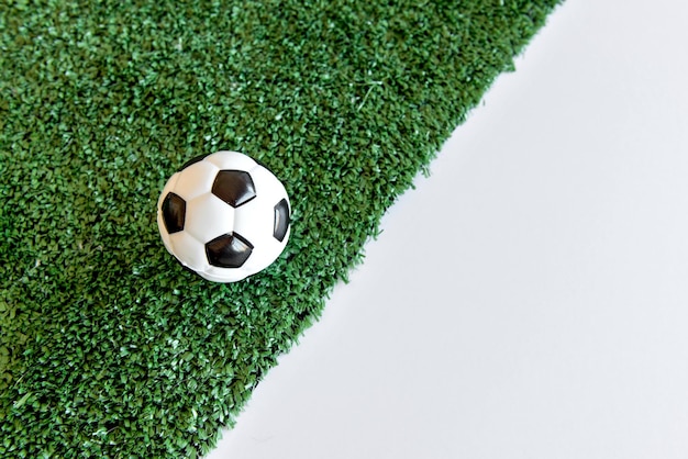 Soccer ball on grass white background