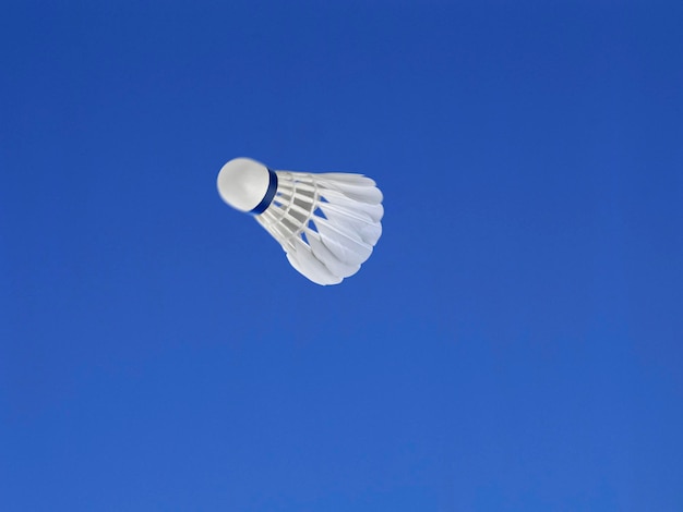 A soccer ball shot in the air with blue sky background