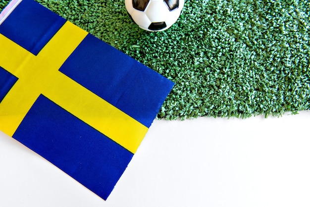 Soccer ball and Swedish flag on white background